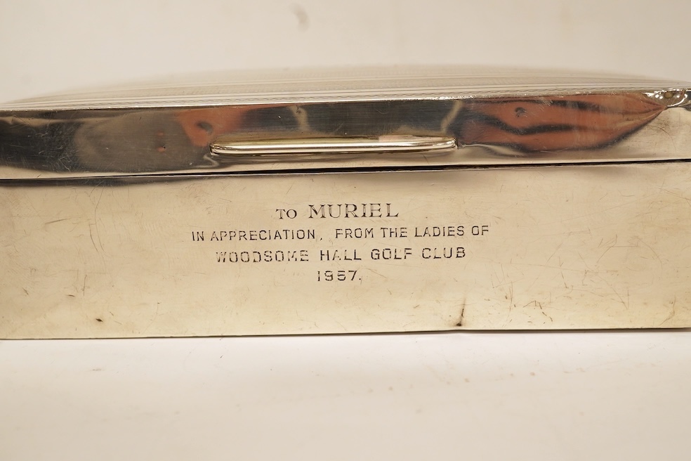 A George V silver mounted rectangular cigarette box, with later engraved inscription, Birmingham, 1932, 13.7cm, together with a similar silver vesta case and two modern silver wine labels. Condition - poor to fair